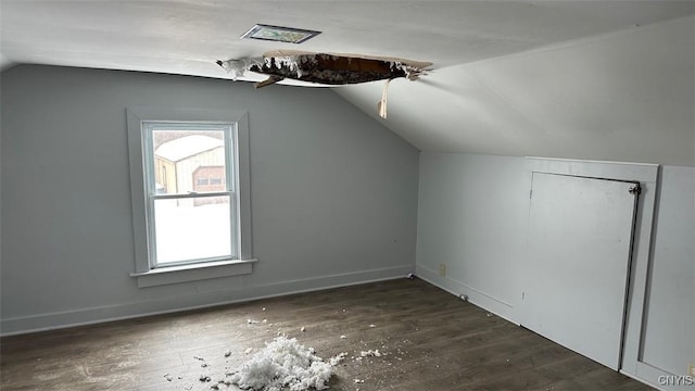 additional living space with vaulted ceiling, baseboards, and dark wood finished floors