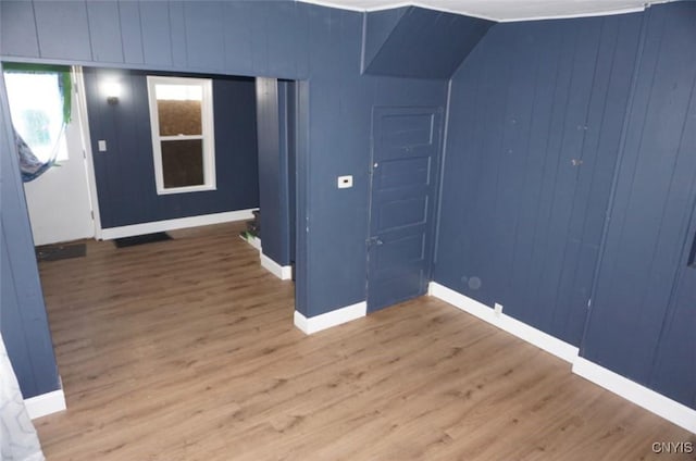 interior space featuring baseboards and wood finished floors