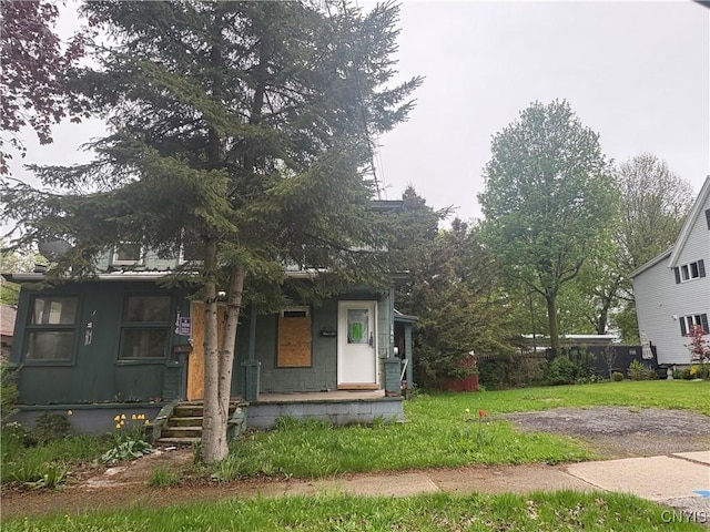 142 E 10th St, Oswego-City, NY 13126 - view of front of house with a porch and a front lawn