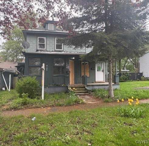 142 E 10th St, Oswego-City, NY 13126 - view of front of house with covered porch and a front yard