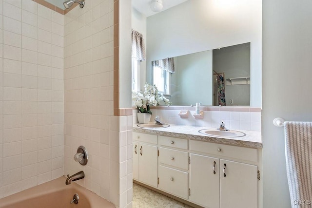 bathroom with double vanity, a sink, shower / bath combo with shower curtain, and decorative backsplash