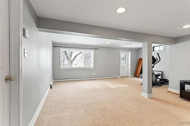 basement featuring a baseboard radiator, light carpet, baseboards, and recessed lighting