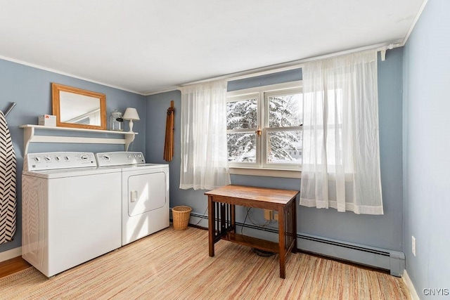 laundry room with laundry area, separate washer and dryer, and crown molding