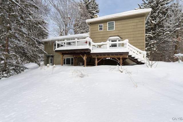 snow covered house with a deck