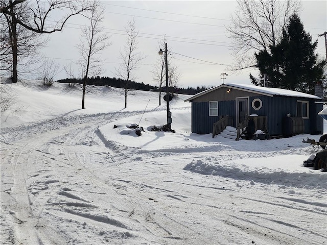 snowy yard with a garage