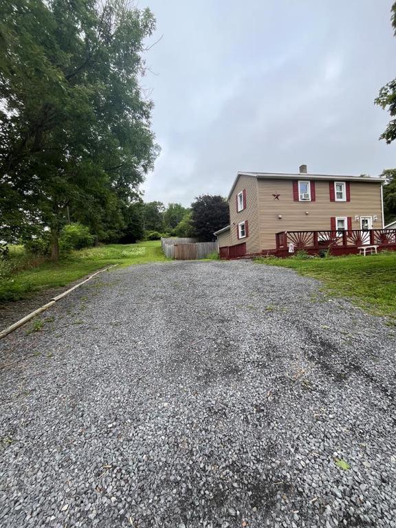 view of front of property with driveway and fence