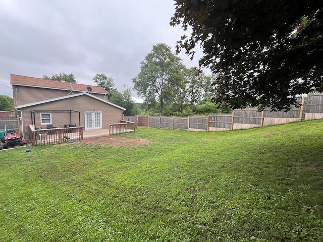 view of yard with a deck and a fenced backyard