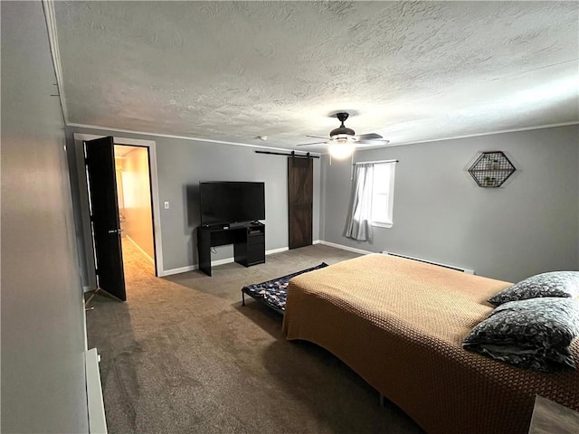 bedroom featuring carpet floors, a barn door, a baseboard heating unit, a textured ceiling, and baseboards