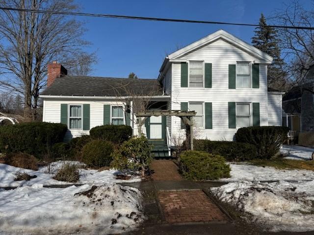 view of front of house featuring a chimney