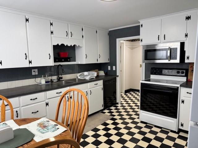 kitchen with light floors, a sink, range with electric cooktop, dishwasher, and stainless steel microwave