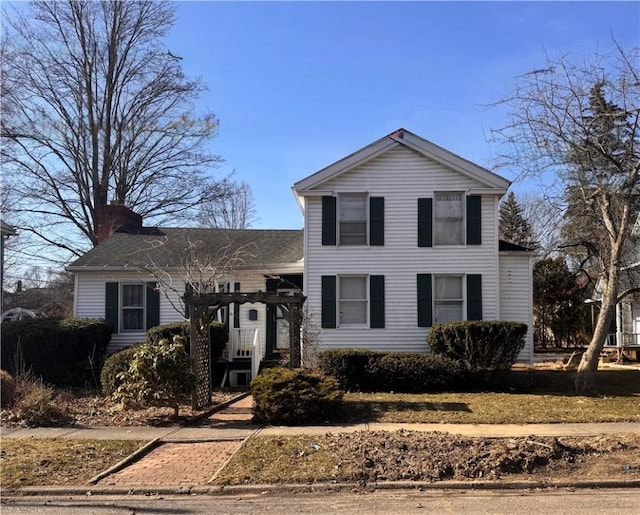 traditional-style home featuring a chimney and a pergola