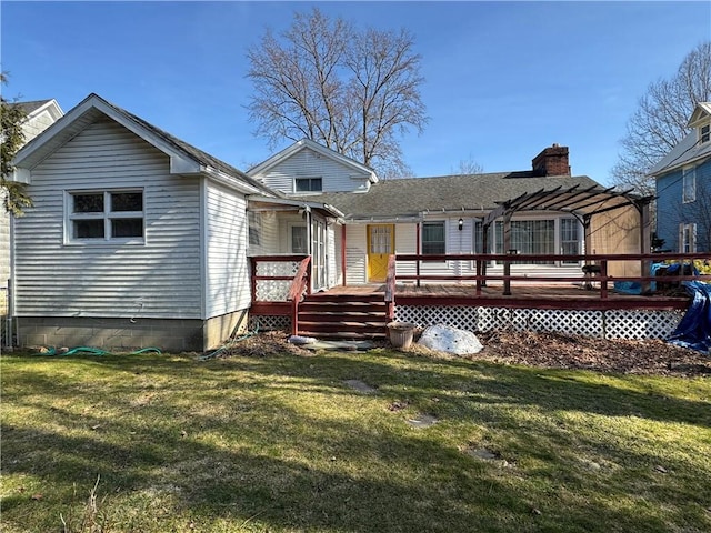 back of house featuring a chimney, a lawn, a pergola, and a wooden deck