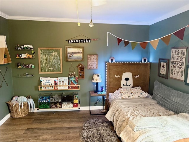 bedroom featuring crown molding, baseboards, and wood finished floors