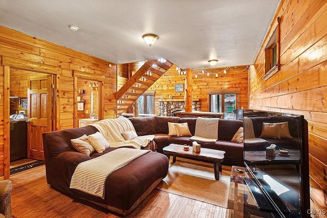 3391 State Route 28, Herkimer, NY 13350 - living area with hardwood / wood-style flooring, wood walls, and a stone fireplace