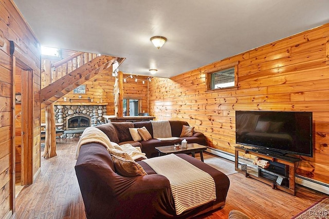 3391 State Route 28, Herkimer, NY 13350 - living room featuring a stone fireplace, wooden walls, and wood finished floors