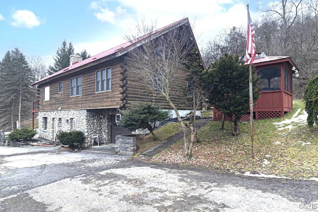 3391 State Route 28, Herkimer, NY 13350 - view of home's exterior featuring a chimney, stone siding, metal roof, and log exterior