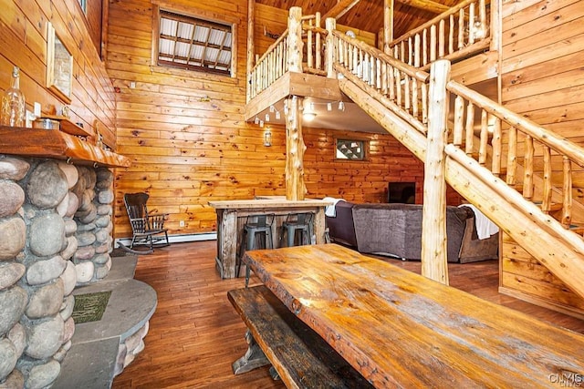 3391 State Route 28, Herkimer, NY 13350 - unfurnished living room with dark wood-style flooring, wood walls, a towering ceiling, and stairs