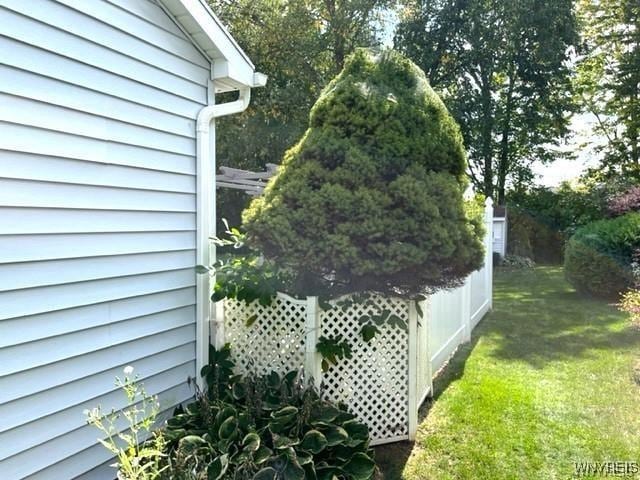 view of side of home with a lawn