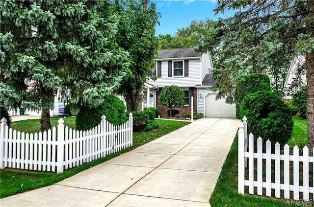 view of front of house with driveway, a fenced front yard, a garage, and brick siding