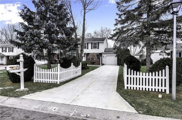 view of front of property with concrete driveway, brick siding, a fenced front yard, and an attached garage