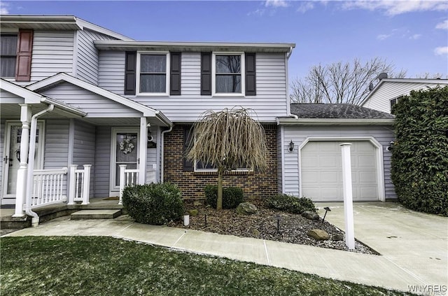 traditional-style home with an attached garage, concrete driveway, and brick siding