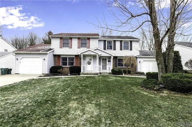 view of front of house featuring a garage, a front yard, concrete driveway, and brick siding