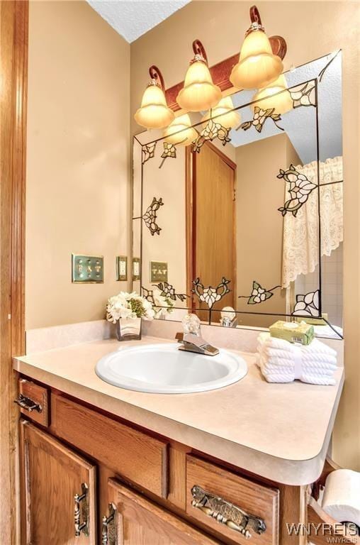 bathroom with a textured ceiling and vanity