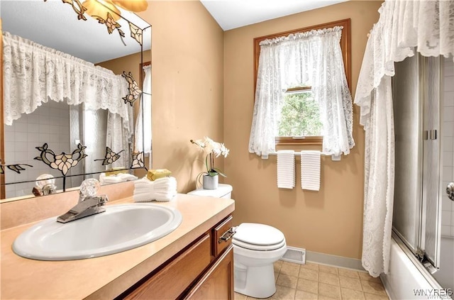 bathroom with baseboards, visible vents, toilet, vanity, and washtub / shower combination