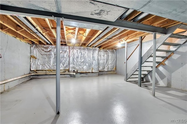 unfinished basement featuring stairway