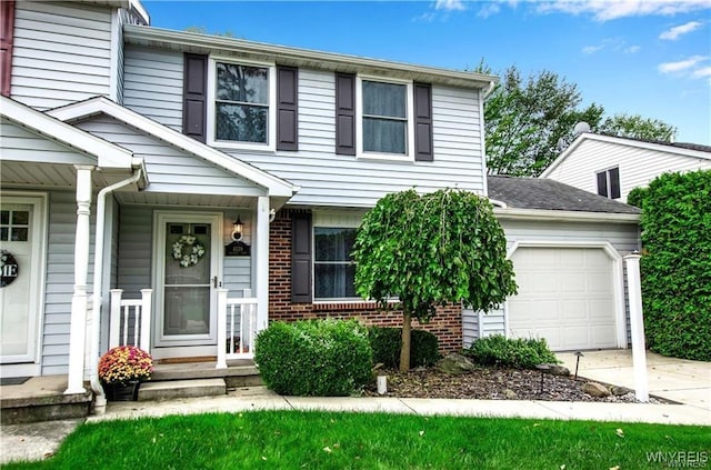 view of front of home with a garage, concrete driveway, and brick siding