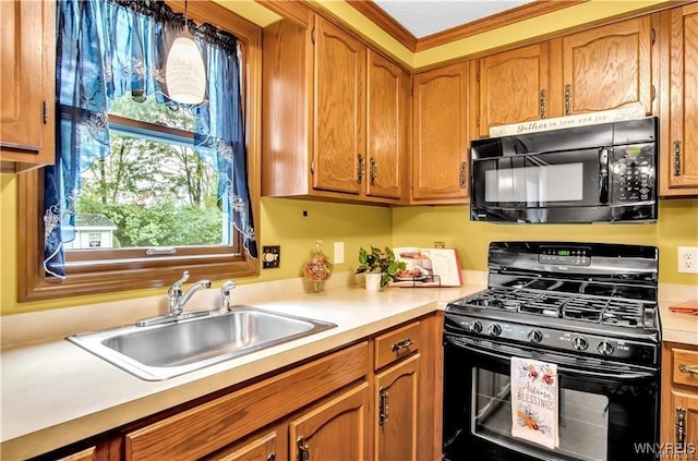 kitchen featuring a sink, light countertops, brown cabinets, black appliances, and decorative light fixtures