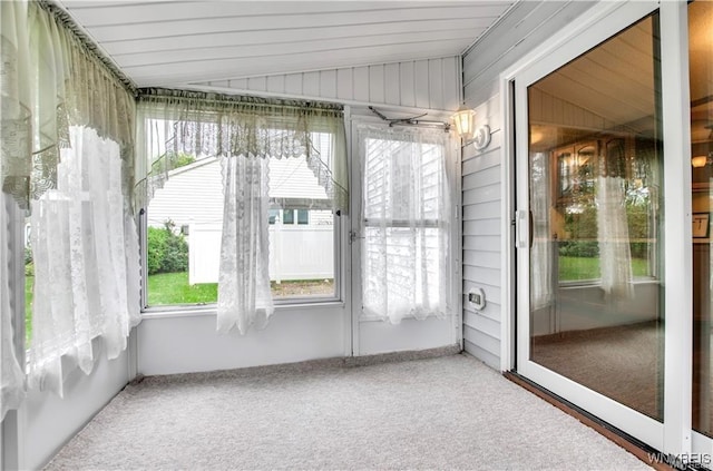 unfurnished sunroom featuring vaulted ceiling