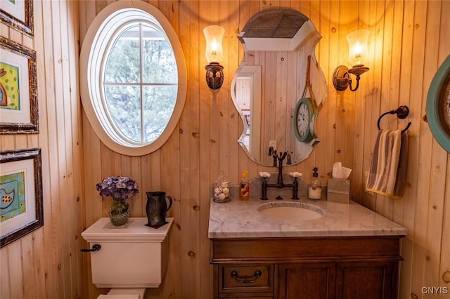 half bath featuring toilet and vanity