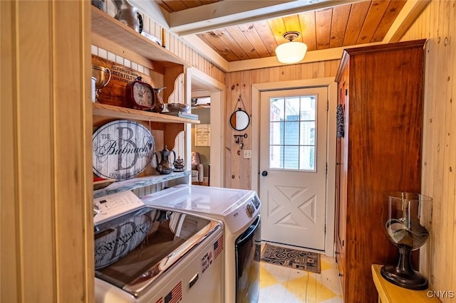 washroom with laundry area, wooden ceiling, wooden walls, and separate washer and dryer