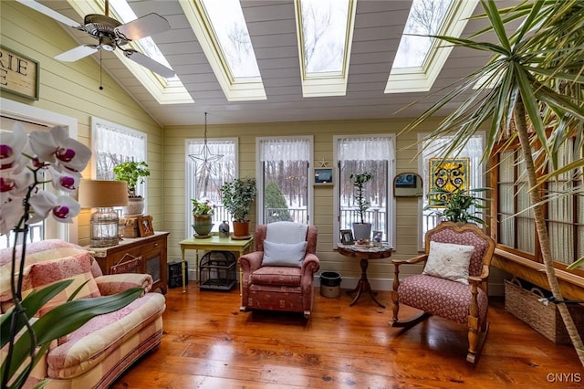 sunroom / solarium with lofted ceiling with skylight and a ceiling fan