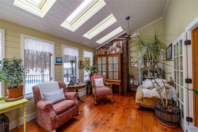 sunroom with vaulted ceiling with skylight