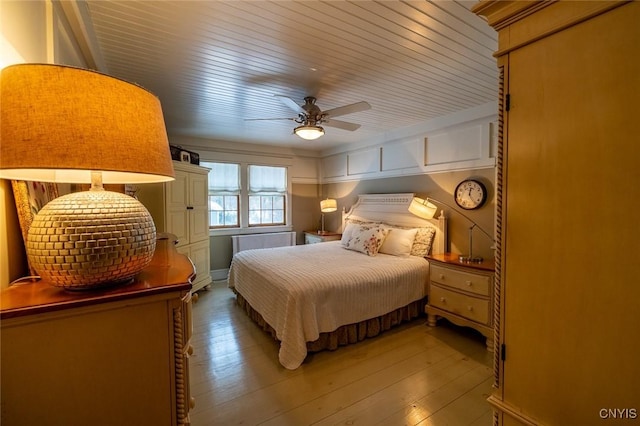 bedroom with a ceiling fan, wood ceiling, and hardwood / wood-style flooring