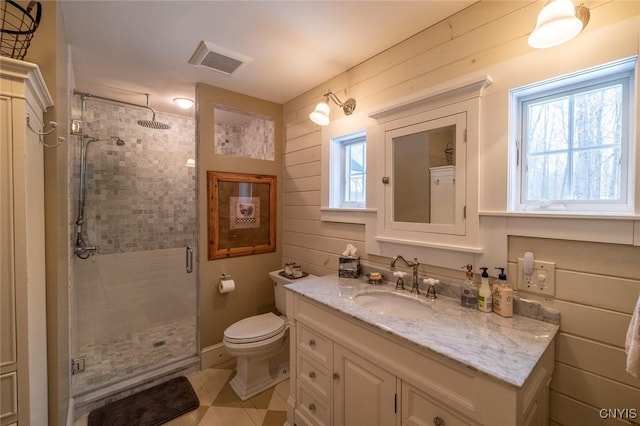 full bath featuring a stall shower, vanity, visible vents, and a healthy amount of sunlight