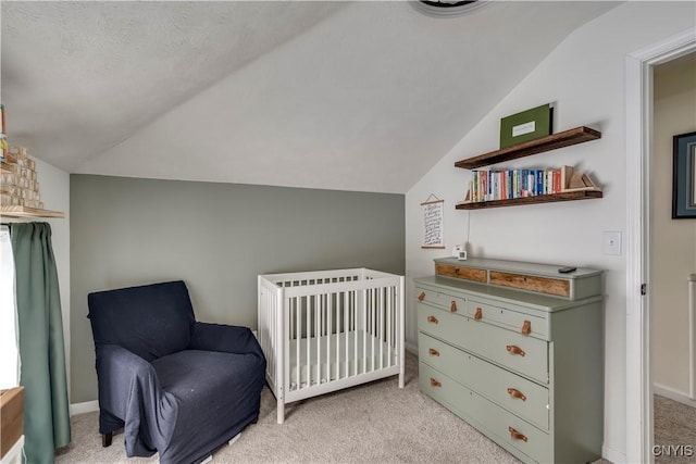 bedroom featuring lofted ceiling, baseboards, and light colored carpet