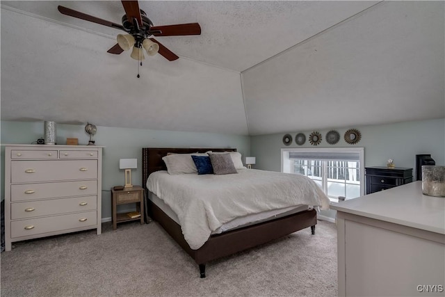 bedroom with a ceiling fan, lofted ceiling, light carpet, and a textured ceiling