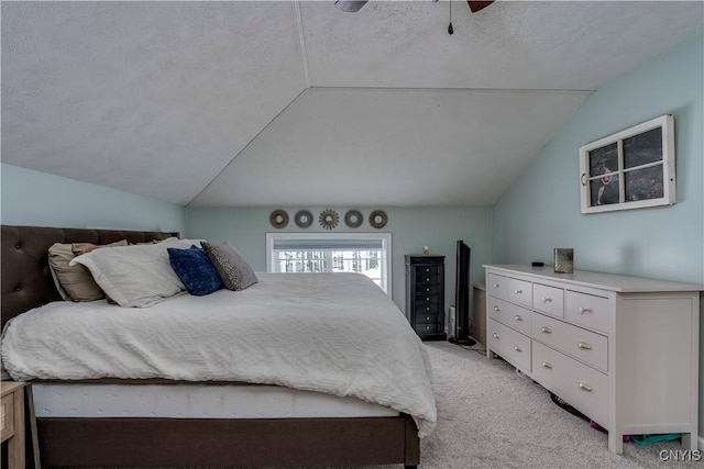 bedroom featuring ceiling fan, a textured ceiling, vaulted ceiling, and light colored carpet