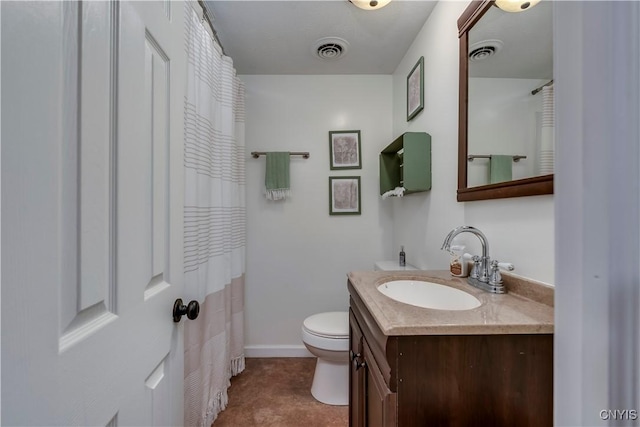 bathroom with baseboards, visible vents, vanity, and toilet