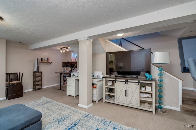 living area with stairway, light colored carpet, a textured ceiling, and baseboards