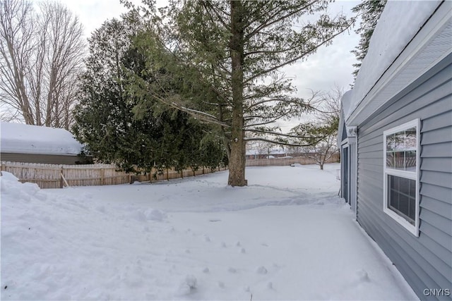 yard layered in snow with fence