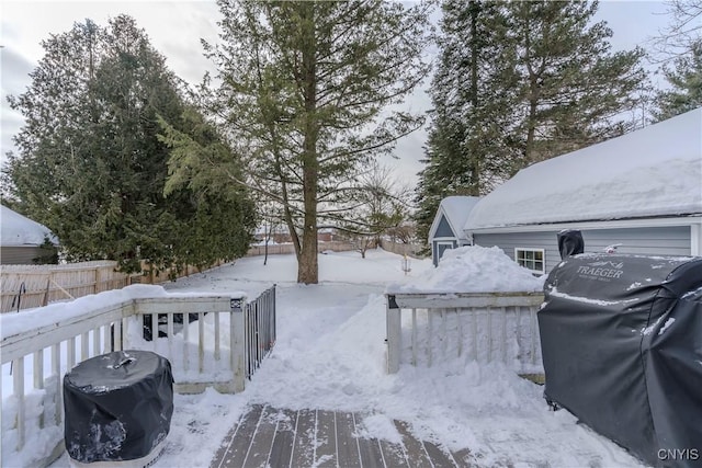 snowy yard featuring fence