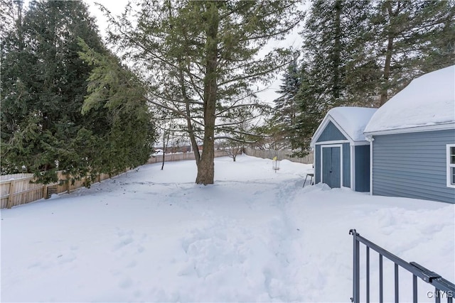 yard layered in snow with fence