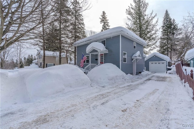 view of front of home with a garage and an outdoor structure