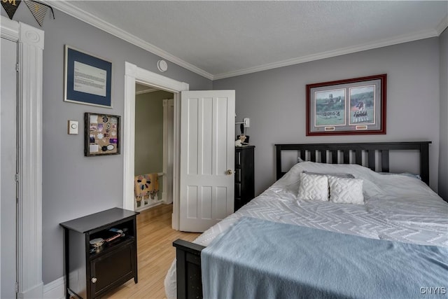 bedroom featuring light wood finished floors and ornamental molding