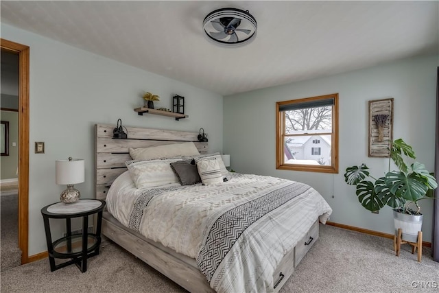 bedroom with light colored carpet and baseboards