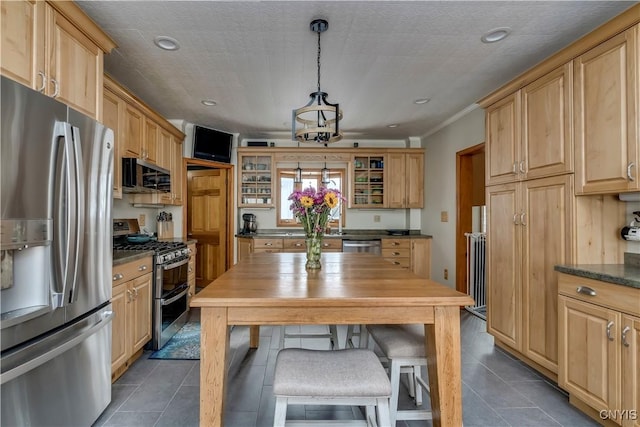 kitchen with stainless steel appliances, dark tile patterned floors, light brown cabinets, and glass insert cabinets